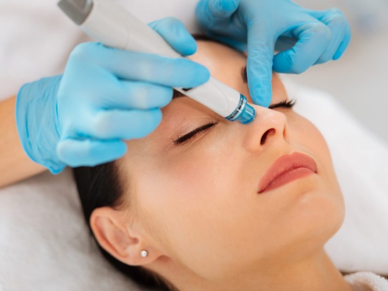 Face cleansing. Face of a nice goo looking woman during hydrafacial procedure in the beauty salon